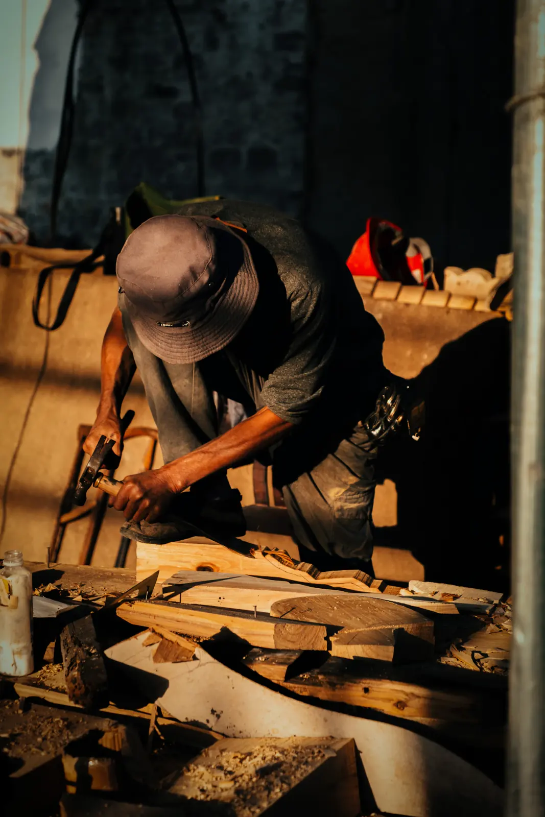 Carpenter shaping a piece of wood at a workshop bench